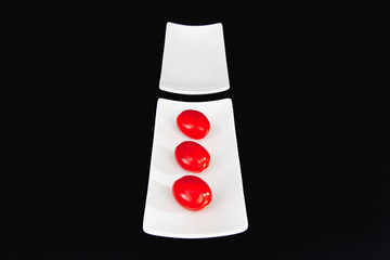 Wall Mural - Red cherry tomatoes on the white table and blacxk background.