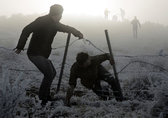 two men escape from enemies through fence