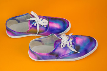 galaxy shoes in the form of walking on top of an orange background