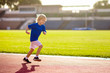 © famveldman - Child running in stadium. Kids run. Healthy sport.
