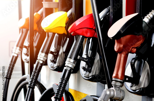 Fotografía colorful fuel gasoline dispenser with sun flare background