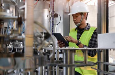 Cropped shot view Manager Technical Industrial Engineer working and control robotics with monitoring system software and industry network connection on tablet.