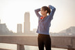 © Garun Studios - Women tied their hair in preparation for a morning exercise in the city. City running Healthy living in the capital. City view behind.  Exercise, fitness, jogging, running, lifestyle, healthy concept.