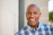 © digitalskillet1 - Happy mature African American man smiling outside.