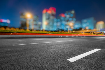 Asphalt highway and modern business district office buildings in Beijing at night, China