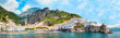 Panoramic view, aerial skyline of small haven of Amalfi village with tiny beach and colorful houses, located on rock, Amalfi coast, Salerno, Campania, Italy
