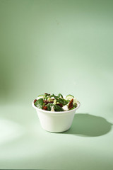 Wall Mural - fresh summer salad in disposable bowl