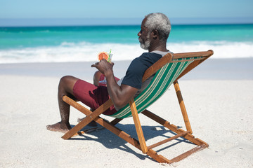 Wall Mural - Old man relaxing at the beach