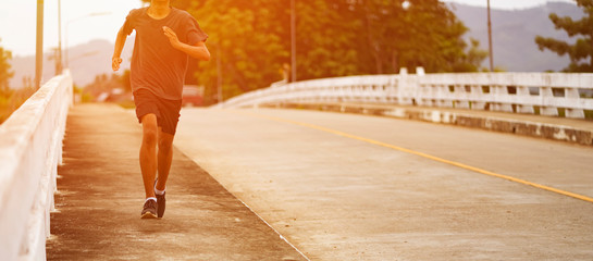 Wall Mural - Young black runner man running on the street be exercise and workout in nature countryside road in the morning. Healthy body exercise sports concept. for banner website