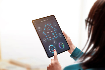 Aufkleber - Smart home control app on tablet display in woman hands. Girl adjusts the lighting in the living room
