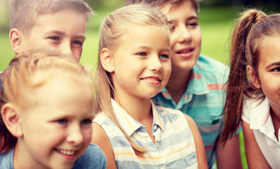 Poster - friendship, childhood, leisure and people concept - group of happy kids or friends in summer park