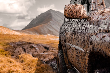 Adventure travel concept background. 4x4 off-road suv car stuck in mud. Adventure travel concept background. Offroad car.