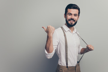 Sticker - Positive confident cool man real estate agent point forefinger copyspace indicate ads promo recommend suggest select pull suspenders wear white pants trousers isolated grey color background