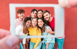 Happy students friends from diverse cultures having fun doing souvenir photo with photographic instant camera paper  - Youth, technology, social trends, lifestyle and friendship concept