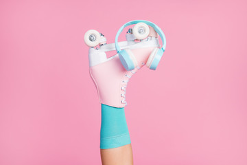 Wall Mural - Cropped view of one nice attractive lovely single leg wearing blue sock skates ear phones modern fashionable radio hit isolated over pink pastel color background