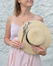 Beautiful Straw Hat And Dry Organic Lavender Flowers Bouquet In Female Hands