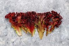 Fresh Red Lettuce On Grey Concrete Background,top View
