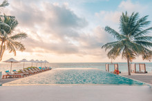 Beautiful Poolside And Sunset Sky. Luxurious Tropical Beach Landscape, Deck Chairs And Loungers And Water Reflection.