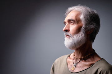 Wall Mural - Studio portrait of handsome senior man with gray beard.