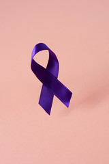 Wall Mural - purple ribbon on a pink background.