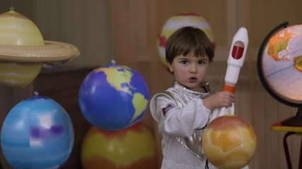 Wall Mural - Space Travel Game Inspiration Spaceship. Little Kid Boy Astronaut Launching Toy Rocket From Spaceport Through Planets. Child Dreamer Playing With Toy Space Rocket Flying Among Planets. SLOW MOTION.