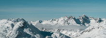 Magical Austrian Alps Panorama View  - Horizontal Image Of Mountains With Clouds, Snowy Peaks And Pine Trees Near St. Anton