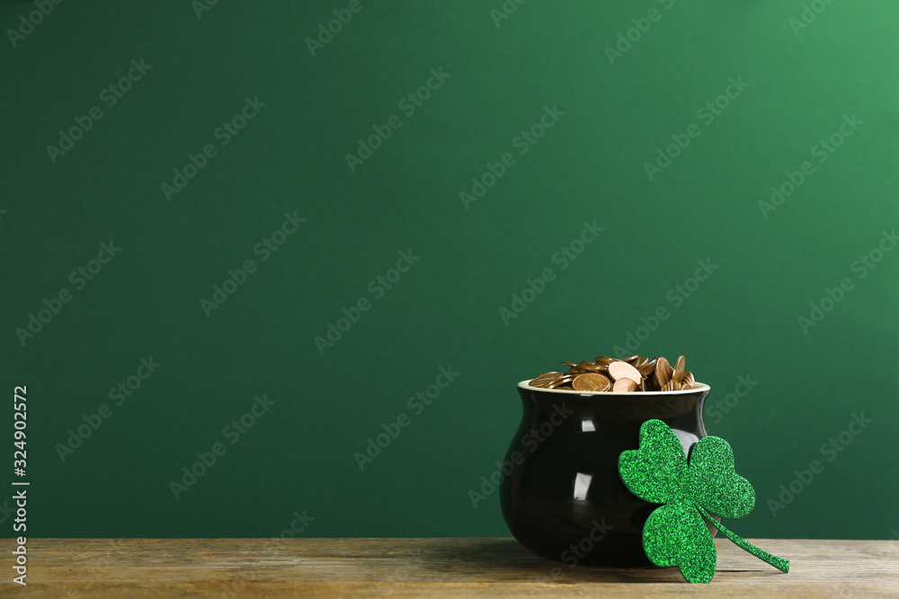 Pot of gold coins and clover on wooden table against green background, space for text. St. Patrick's Day celebration - obrazy, fototapety, plakaty 
