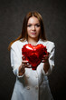 © DSMT - Beautiful girl in a white jacket with a red balloon heart in her hands