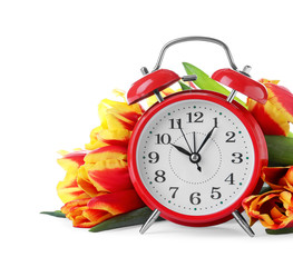 Poster - Red alarm clock and spring flowers on white background. Time change