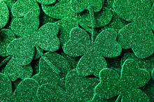 Glitter Green Clover Leaves As Background, Top View. St. Patrick's Day Celebration