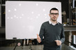 © Synergic Works OÜ - Portrait of businessman standing in front of a whiteboard in office