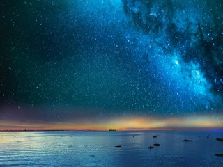 Wall Mural - starry blue night sky at sea sunset background 