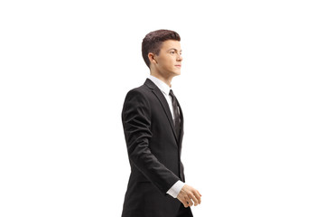 Wall Mural - Young handsome man in a black suit walking