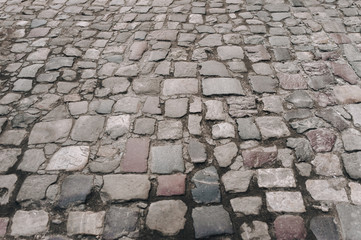 Wall Mural - The gray paving stones close up. The texture of the old dark stone. Road surface. Vintage, grunge.