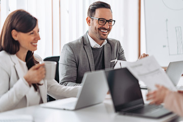 Portrait of cheerful elegant businessman smiling at the meeting