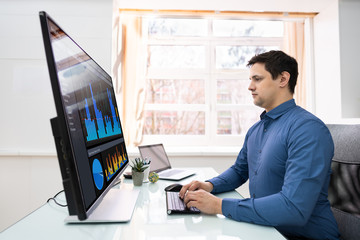 Poster - Businessman Analyzing Graphs On Computer