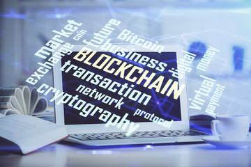 Multi exposure of blockchain and crypto economy theme hologram and table with computer background. Concept of bitcoin cryptocurrency.