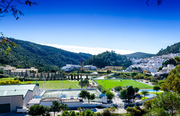 top view of a two small football fields in Benahavis Andalucia Spain, lawnmower cutting grass on the football stadium, beautiful colorful nature and stunning green