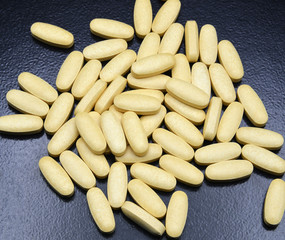 yellow pills on black background