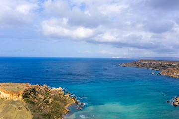 Ghajn Tuffieha, Malta - Aerial panoramic view of the coast of Ghajn Tuffieha with Gnejna Bay, Riviera Bay and Golden Bay at sunrise