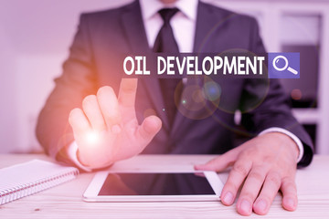 Poster - Writing note showing Oil Development. Business concept for act or process of exploring an area on land or sea for oil Male human wear formal clothes present use hitech smartphone