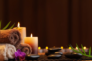 Aromatherapy, spa, beauty treatment and wellness background with massage stone, orchid flowers, towels and burning candles...