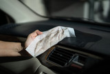 Fototapeta Przestrzenne - hand with dirty dust in microfiber cloth cleaning console in front of car