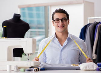 Young man tailor working on new clothing