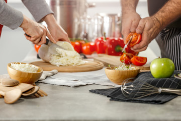 Wall Mural - Hands in kitchen making meal.Table of free space for your decoration and fresh vegetables. 