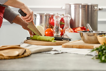 Wall Mural - Hands in kitchen making meal.Table of free space for your decoration and fresh vegetables. 