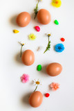Fototapeta Mapy - Easter pattern of Eggs with flowers and candies on the white background. Easter concept. Healthy feeding concept. 