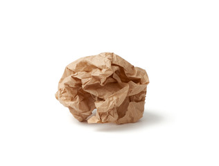 crumpled ball of brown sheet of parchment paper isolated on white background