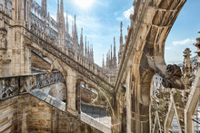 Milan Cathedral Roof, Italy, Europe. Milan Cathedral Or Duomo Di Milano Is Top Landmark Of Milan City. Beautiful Gothic Architecture Of Milan Against Blue Sky.
