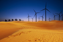 Renewable Energy In Desert Sand Dunes At Sunset Concept With Solar Panels And Wind Turbines
